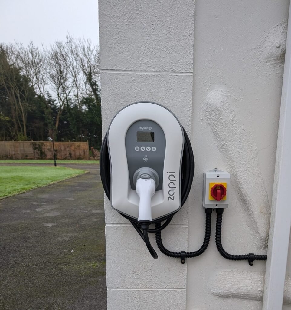 Residential EV charger installation on brick garage wall